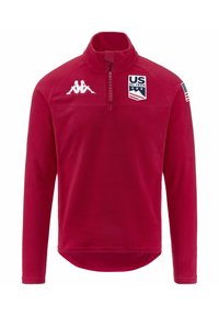 Pullover in pile rosso con zip a quarto di giro, logo Kappa bianco, patch della squadra olimpica di sci degli Stati Uniti e dettaglio con bandiera americana sulla manica. Tessuto liscio, maniche lunghe.