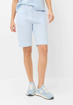 Person wearing light blue and white vertical striped knee-length shorts with light blue sneakers and a light blue shirt.