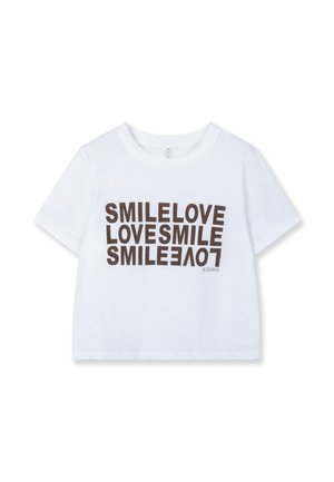 White cotton cropped t-shirt featuring bold, repeating text "SMILE LOVE" in brown. Simple crew neck and short sleeves.