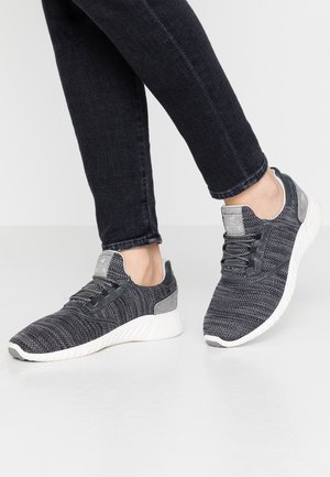 Gray athletic sneakers feature a textured knit upper, white midsole, and gray accents. The design includes laces and a padded collar.
