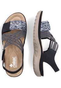 Zwarte en grijze gevlochten sandaalbanden met een gevoerde binnenzool, verstelbare klittenbandsluiting en een getextureerde rubberen zool voor grip.