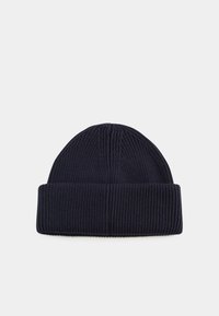 Navy knitted beanie with ribbed texture, folded cuff, and subtle seam detailing on the crown. Material appears soft and warm.