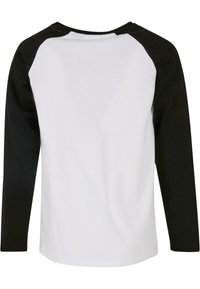 Langærmet skjorte med sort raglan-design og hvid krop. Fremstillet af blødt bomuld, med en rund hals og en glat tekstur.