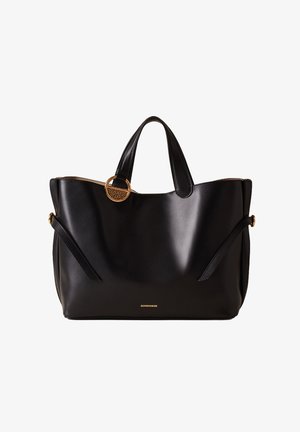 Black leather tote bag with gold hardware, featuring a round accent detail, two handles, and side pockets for added functionality.