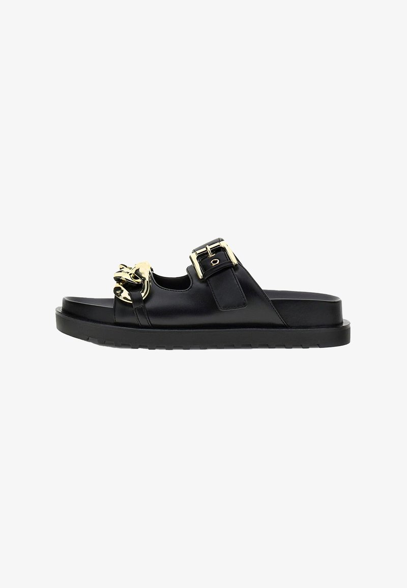 Black slip-on sandal with thick sole, featuring a gold chain detail on front strap and a gold buckle on the side strap.
