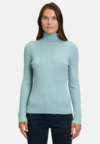 Light blue ribbed turtleneck sweater with fitted long sleeves and a textured fabric. Seamless design and straight hem at the waist.