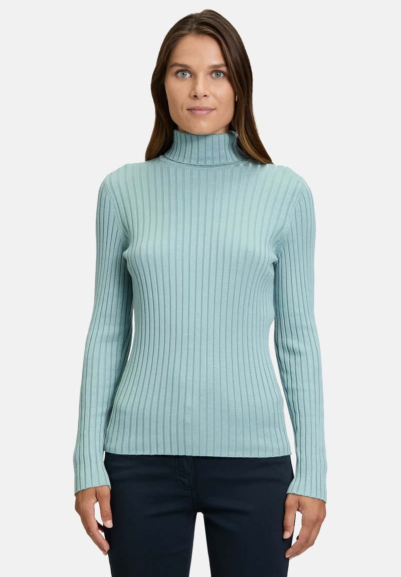 Light blue ribbed turtleneck sweater with fitted long sleeves and a textured fabric. Seamless design and straight hem at the waist.