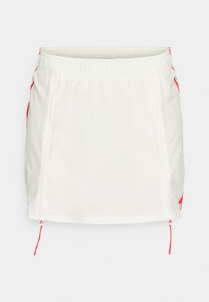 White athletic skirt with elastic waistband, featuring red drawstrings and side zippers. Smooth fabric, knee-length design, no patterns.