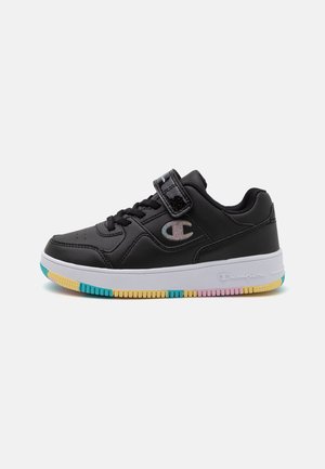 Czarny niski sneaker z sznurowadłami, paskiem na rzep, tęczowym logo, białą podeszwą i wielobarwnymi fragmentami bieżnika w kolorach niebieskim, żółtym i różowym.