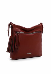 Red leather handbag with a textured finish, slouchy shape, top zipper closure, and a decorative tassel on the side. Silver branding detail.