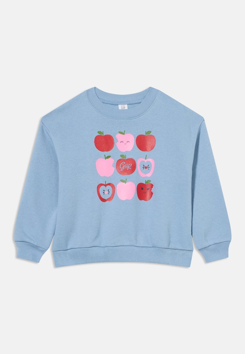Sweat-shirt bleu clair avec une grille de pommes rouges et roses, certaines avec des visages, une avec le mot "Gap" dans la pomme centrale.
