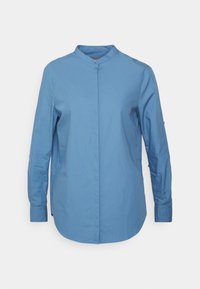 Ljusblå kragefri skjorta med knappar, långa ärmar, slät bomullstyg, subtil lyster, rak fåll och minimalistisk design.