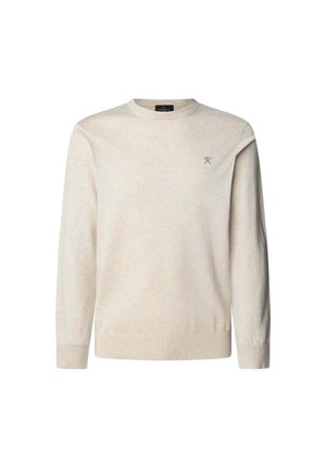 Pull en beige clair, avec un col rond, des manches longues, des poignets et un ourlet côtelés, et un petit emblème sur la poitrine.