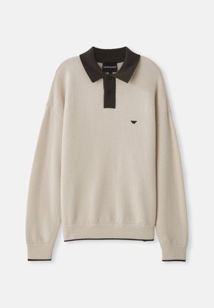 Long-sleeve beige sweater with black collar and button placket, black logo on chest, ribbed cuffs, and hem with black trim.
