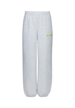 Helehallid dressipüksid elastse vöökohaga ja mansettidega, millel on vasakul reiel väike kollane tikitud logo.