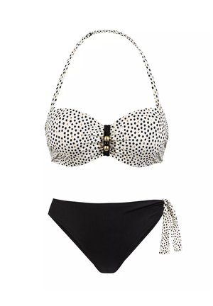 Czarnobiały bikini w kropki, z luksusowym bandeau na górze z dekoracyjnym czarnym zapięciem i wysokim stanem na dole z bocznymi wiązaniami.
