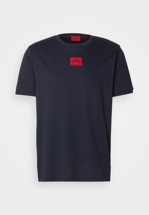 Black cotton t-shirt with short sleeves featuring a red square logo labeled "HUGO" on the chest. Classic crew neck design.