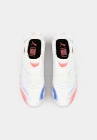 Puma sports shoes in white with pink and blue gradient accents, textured upper, traditional laces, and printed logo on the tongue.