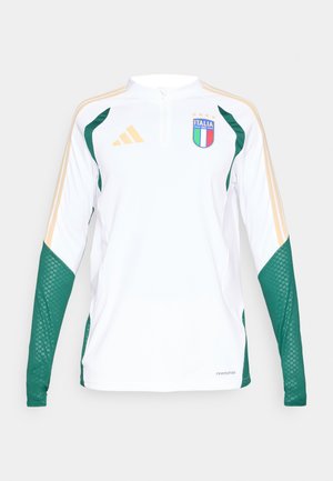 Λευκή μακρυμάνικη μπλούζα με πράσινες και χρυσές λεπτομέρειες. Διαθέτει κλείσιμο με φερμουάρ μέχρι το ένα τέταρτο του λαιμού, υφασμάτινα μανίκια και το εθνόσημο της Ιταλίας.