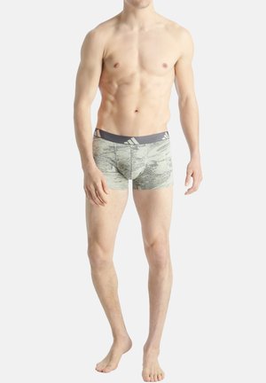 Boxer da uomo in grigio chiaro con un sottile motivo astratto. Presenta una vita elasticizzata grigia con branding e una vestibilità aderente.