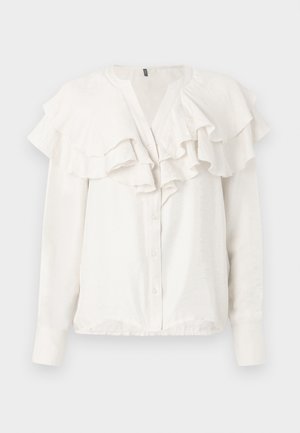 Valkoinen pitkähihaisia paita, jossa on röyhelökaulus ja -etupuoli. Paidan edessä on napitus ja se on valmistettu pehmeästä ja teksturoidusta kankaasta.