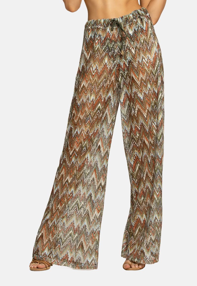 Pantaloni larghi e fluidi con un motivo a zigzag multicolore. Realizzati in tessuto leggero con vita regolabile tramite coulisse. I colori includono toni terrosi.