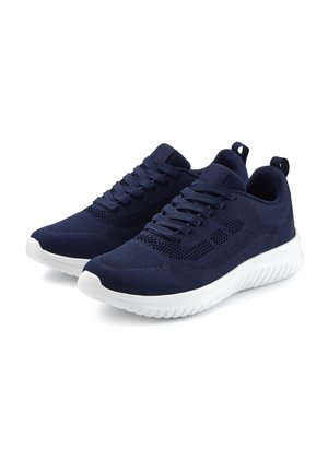 Pair of navy blue knit sneakers with white soles and laces, featuring ventilation holes and pull tabs at the heel.