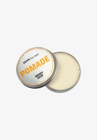 Latta di metallo di pomata opaca per uomini etichettata "Capelli Sconnessi" con ingredienti tra cui sangue di drago, incenso e patchouli, coperchio parzialmente aperto.