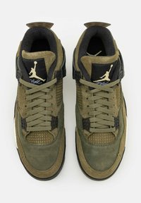 Scarpe da ginnastica sportive in camoscio verde e mesh con dettagli neri, dotate di una chiusura con lacci, collo imbottito e logo iconico sulla linguetta.