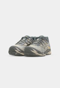 Running shoes with a mesh upper in grey, silver, and yellow accents. Features a cushioned sole and laces, designed for comfort and support.