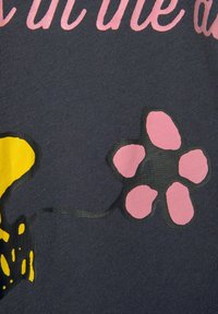 Dark navy fabric featuring a pink flower design with a yellow accent. The flower has rounded petals and a thin black outline.