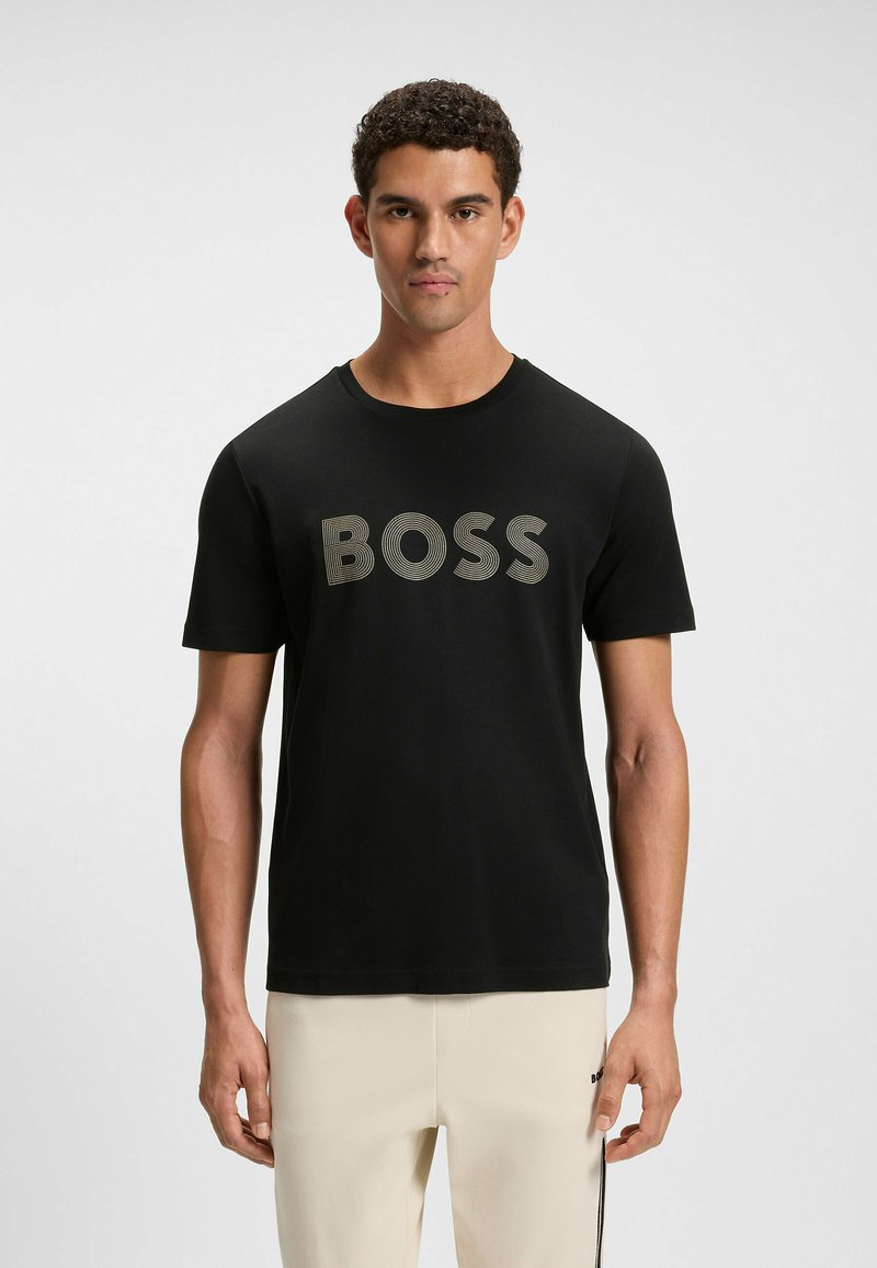 Black short-sleeve t-shirt featuring a prominent "BOSS" logo in textured gray, crafted from smooth fabric with a classic crew neckline.