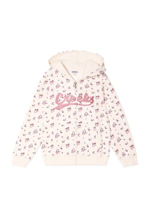Light cream zip-up hoodie with pink floral pattern, glittery "Creeks" logo, and a hood. Made of soft fabric with ribbed cuffs.