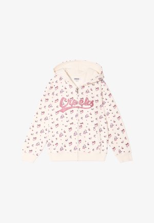 Lichtcrème zip-up hoodie met een roze bloemenpatroon, glitterend "Creeks" logo en een capuchon. Gemaakt van zachte stof met ribbels bij de manchetten.