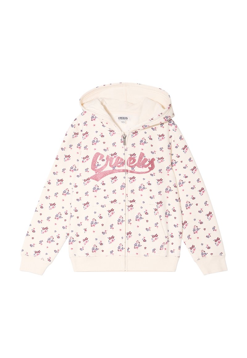 Sudadera con cremallera de color crema claro, con un patrón floral rosa, logo brillante de "Creeks" y capucha. Está hecha de un material suave con puños acanalados.