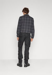 G-STAR ROVIC ZIP TAPERED - Cargo hlače - black