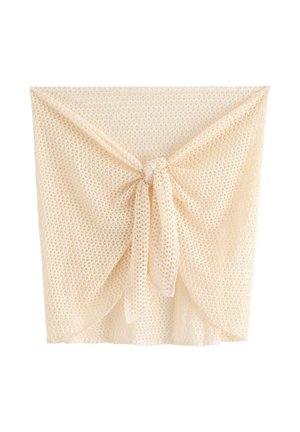 Beige åbenstrikket hæklet omslagsnederdel med knude foran, semitransparent tekstur og let, åndbart stof.