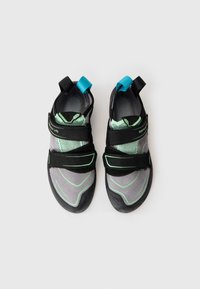 Gray and black climbing shoes with green accents, featuring a synthetic upper, Velcro straps, and rubber soles for grip.