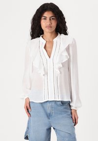 Weiße Bluse mit gerafftem Vorderteil, tiefem V-Ausschnitt und vertikalen Streifendetails. Leichtes Material und lange Ärmel mit elastischen Bündchen.