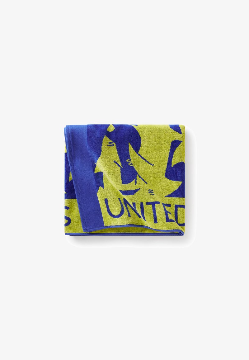 Serviette multicolore avec des tons vifs de jaune et de bleu, ornée d'un grand design graphique et du texte "UNITED" en lettres grasses. Texture douce.