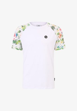 Valge T-särk lillemustriga lühikeste varrukatega, ümara kaelusega ja musta ümmarguse logoga ees. Pehme puuvillane materjal.