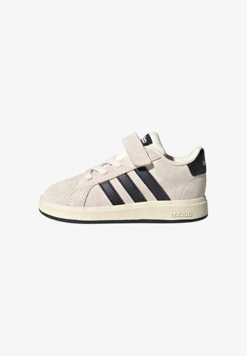 Light grey suede sneaker with black stripes and heel accent. Features lace and velcro closure, flat rubber sole, and textured stitching.