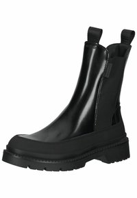 Bottine noire en matériau brillant avec des panneaux latéraux élastiques, une semelle en caoutchouc épaisse et des languettes pour faciliter l'enfilage.