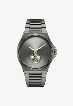 Roestvrijstalen horloge met een donkergrijze geborstelde wijzerplaat, gouden wijzers en een blootgelegd uurwerk. Voorzien van een verbonden metalen armbandontwerp.