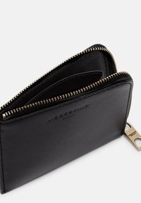 Schwarze Lederbrieftasche mit strukturiertem Finish, goldener Reißverschluss und geprägtem Logo; verfügt über mehrere Fächer für Karten und Bargeld.