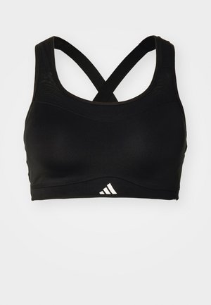 Svart sports-BH med en glatt tekstur, kryssryggstropper og en hvit Adidas-logo foran. Designet for aktiv bruk.