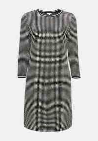 Robe à carreaux noire et blanche longueur genou avec manches trois-quarts et encolure ronde, avec bordure rayée aux poignets et au col.
