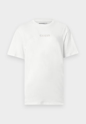 Fehér, rövid ujjú, kerek nyakkivágású póló, amelynek mellkasán középen világosszürke „GUESS” logó található.