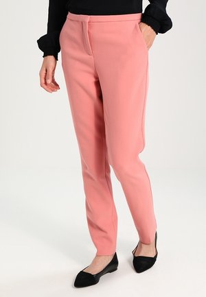 Dusty pink tailored trousers with a straight leg design, featuring side pockets and a flat front. Worn with black flats.