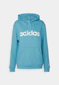 Blå bomullshoodie med en kenguruficka, dragsko och en vit "adidas"-logotyp på framsidan. Har ribbade cuffs och fåll.